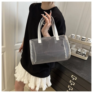 Silver mesh barrel makeup bag featuring a transparent texture and portable top handles