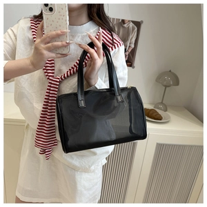 Detail of a large capacity black mesh toiletry bag featuring sturdy double handles