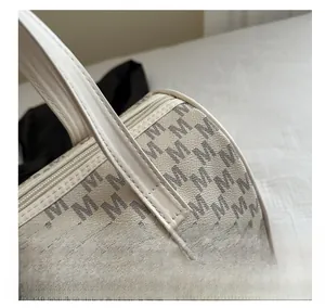 Detailed close-up of textured leather surface with M-pattern on the cylindrical bag