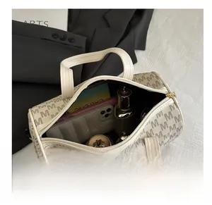 Spacious interior of beige Boston bag showing storage for phone and makeup