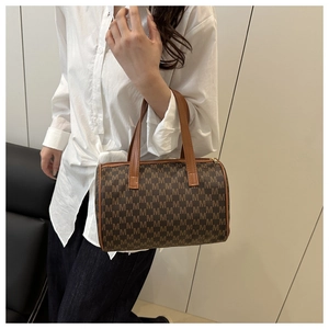 Close-up of brown monogram Boston bag with leather handles and metallic zipper detail