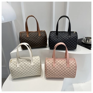 Detail view of four Boston bags in coffee, black, white and pink with M-pattern print