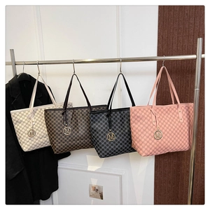 Detailed row of tote bags in four colors featuring M-letter monogram print and metal charms