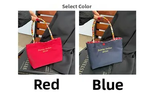 Detail of red and blue tote bags featuring rainbow braided handles and gold lettering