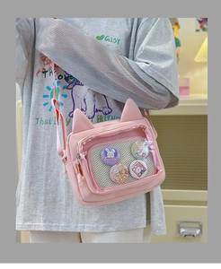 Pink cat-ear crossbody ita bag featuring clear window with cute rabbit badges detail