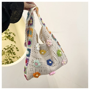 Detail of colorful 3D crochet flowers on a beige cotton woven shoulder bag