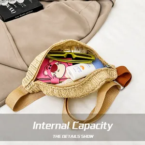 Macro shot showing the spacious interior of the woven straw waist bag for summer travel