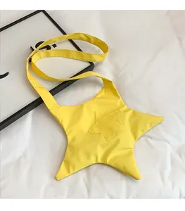 Detail of a bright yellow star-shaped crossbody bag made of lightweight canvas fabric