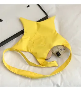 Detail of star-shaped crossbody bag interior showing storage space for phone and makeup