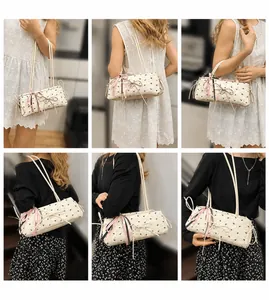 Detail view of pink and beige underarm bags with bow accents shown on models