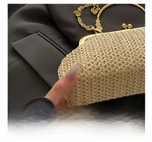 Detail shot of beige straw shell bag texture with golden clasp and fine chain