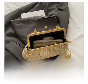 Internal view of beige straw woven bag with gold metal frame showing storage capacity