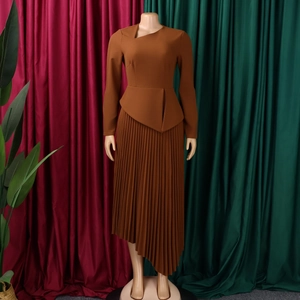 Detail of elegant dark coffee midi dress with asymmetric peplum waist and pleated skirt
