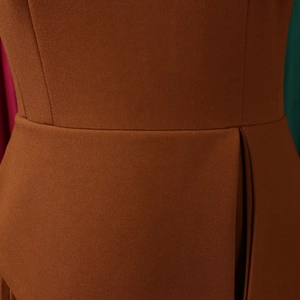 Detail of high-waisted caramel brown dress showing fine fabric texture and waist pleat