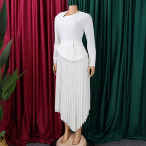 Detail of elegant white peplum dress featuring asymmetric pleated skirt and fitted waist