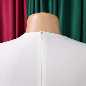 Close-up of invisible back zipper on white dress with high-quality stitching details