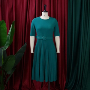 Elegant short-sleeve pleated dress in dark green featuring a matching buckled waist belt