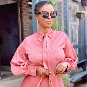 Elegante rosa Satinbluse mit Schleifenausschnitt und modischen Puffärmeln