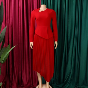 Detail of red asymmetric pleated midi dress with unique cutout neckline and long sleeves
