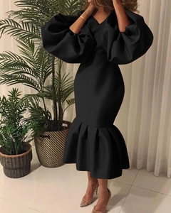Detail of elegant V-neckline and voluminous puff sleeves on a black fishtail dress