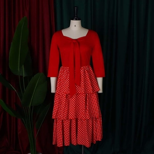 Detail of red tiered polka dot skirt with elegant bow neckline on a mannequin