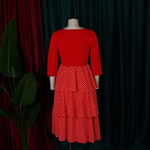 Rear view of polka dot tiered dress featuring red three-quarter sleeves and round neck