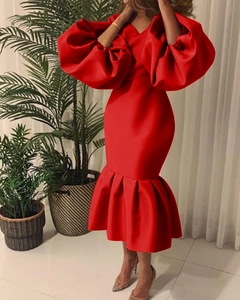 Detail of red satin V-neck dress with dramatic puff sleeves and ruffled fishtail hemline