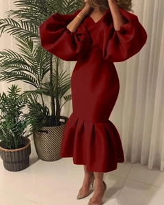 Detail of burgundy V-neck evening gown featuring oversized puff sleeves and mermaid hem