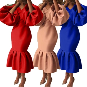 Close-up of elegant v-neck mermaid dresses with dramatic puff sleeves in three vibrant colors