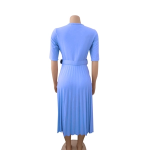 Detail of light blue pleated midi dress with matching belt and elegant high waist cut