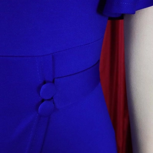 Close-up of royal blue dress waist with matching fabric buttons and textured fabric details
