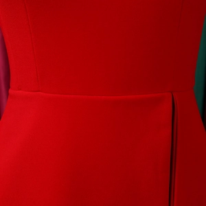 Close-up of red dress showing premium fabric texture and pleated waist stitching detail