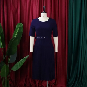 Detail of navy blue short sleeve pleated dress with a matching belt on a mannequin