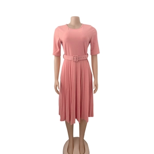 Close-up of pink pleated dress featuring a crew neck and matching square buckle belt