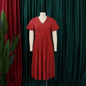 Detail of V-neck rust red pleated dress with ruffle sleeves and matching belted waist