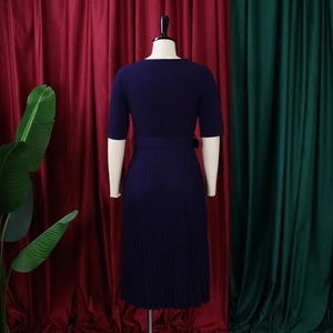 Navy blue short sleeve dress detail featuring fine pleated skirt and matching waist belt