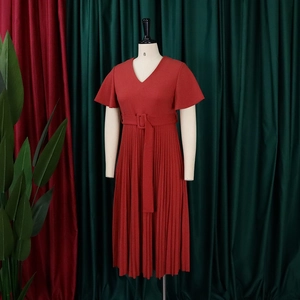 Detailed view of brick red pleated dress with V-neck and elegant ruffled short sleeves