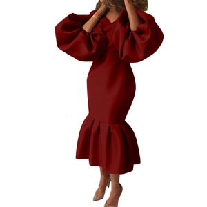 Detail of the elegant deep red V-neck dress featuring puff sleeves and a fishtail hemline