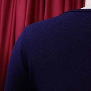 Detailed close-up of dark purple crepe fabric texture on a short-sleeve dress neckline
