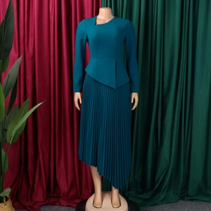 Detail of elegant asymmetric pleated hem and high waist wrap on dark teal midi dress