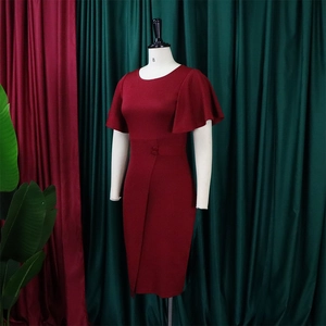 Close-up of wine red sheath dress featuring ruffle sleeves and decorative waist buttons