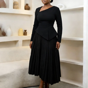 Detail showing asymmetric cutout neckline and pleated hem of elegant black midi dress