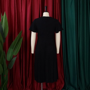 Back view of a black V-neck pleated dress with ruffle sleeves and high waist design