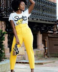 Detail of high waist yellow trousers with matching wide belt and Simba graphic tee