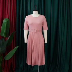 Elegant short sleeve pleated dress in lotus pink featuring a matching adjustable waist belt
