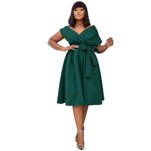 Detail of dark green dress with elegant off-shoulder V-neckline and bow tied at waist
