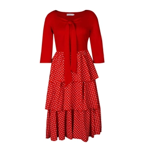Detailed view of red tiered polka dot skirt and bow collar on a dress for women