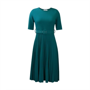 Detail view of dark green pleated dress featuring a round neck and waist belt