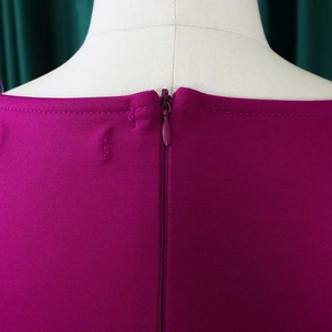 Detail of high-quality invisible back zipper on a rose red professional dress