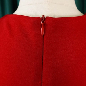 Detail of red dress showing the back invisible zipper and textured woven fabric